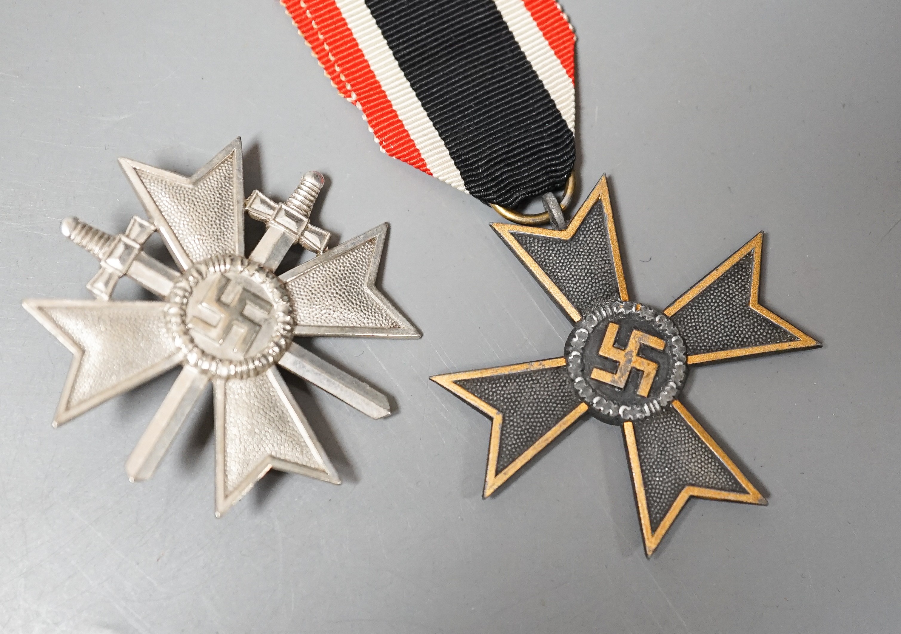 A WW2 German War Merit Cross 1st Class With Swords, stamped 1, a War Merit Cross 2nd Class Without Swords